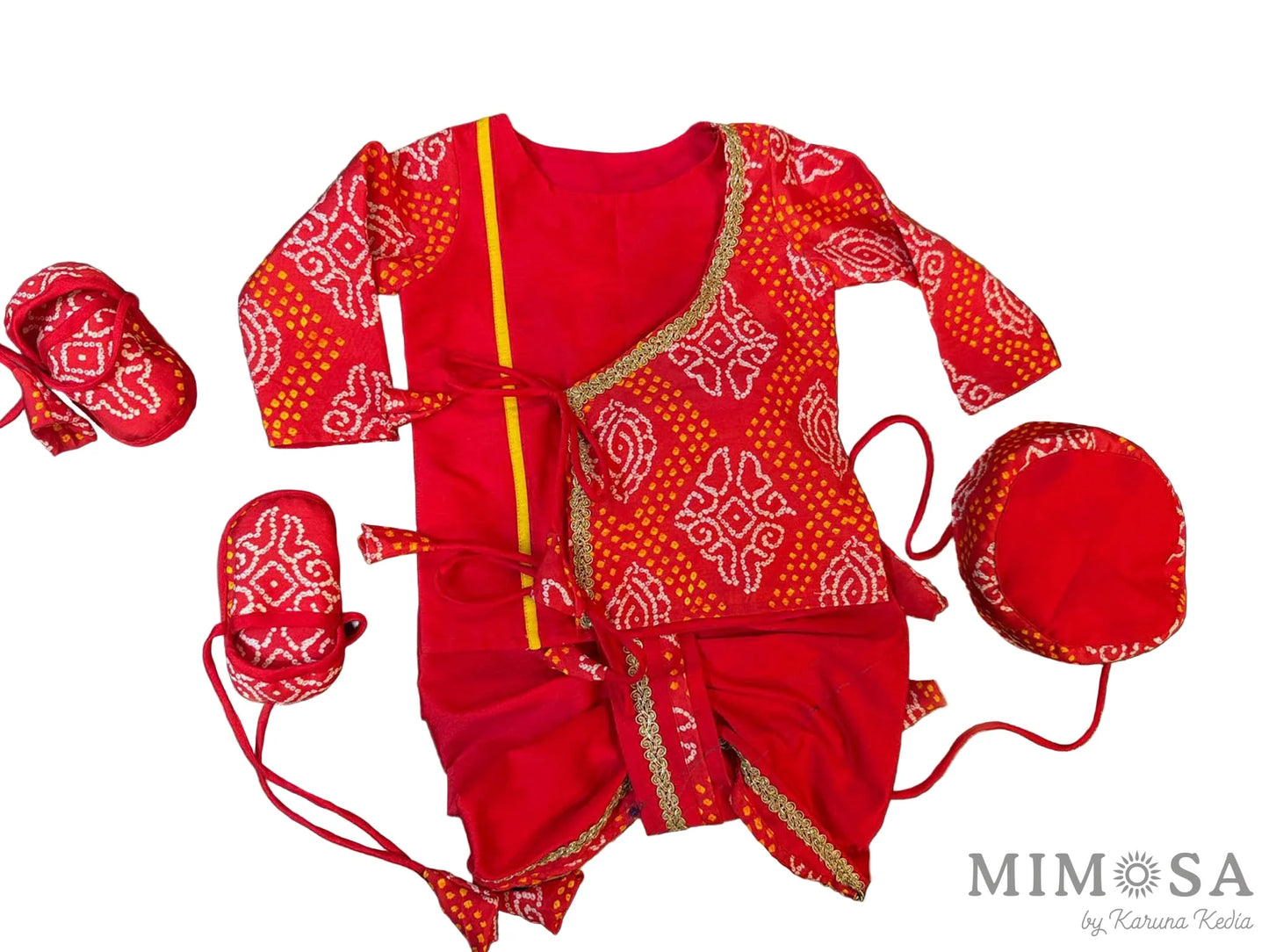 Red children's outfit with white patterns on a dark surface