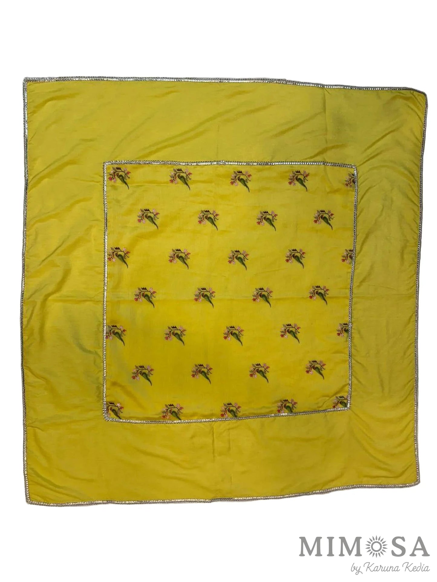 Yellow fabric square with a pattern on a white background