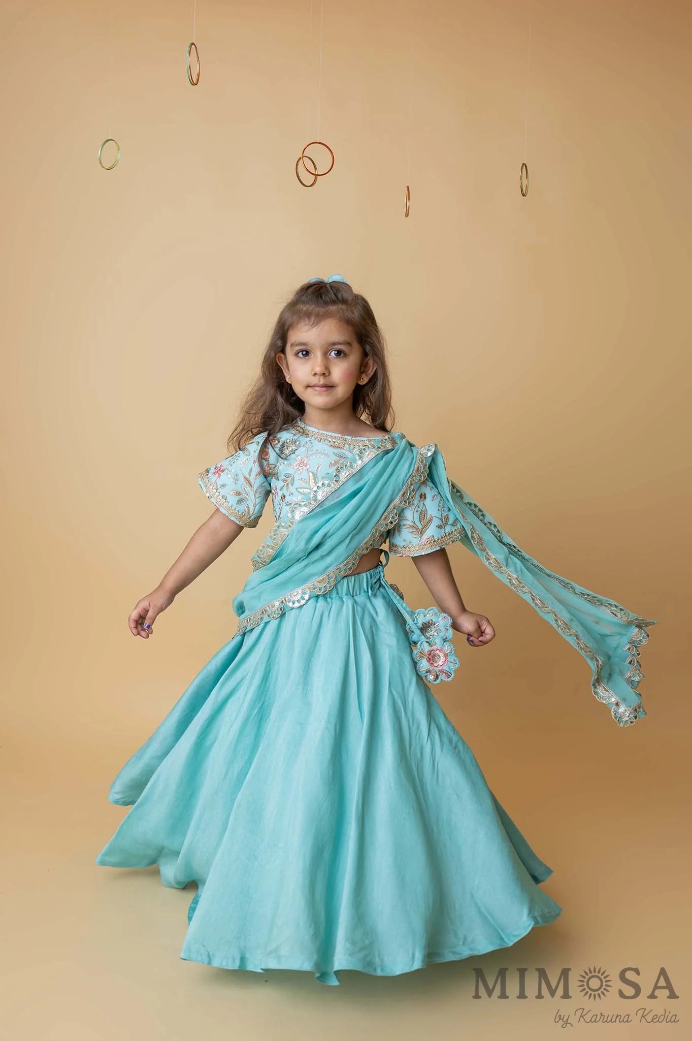 Teal lehenga with embroidered blouse and draped dupatta pallu