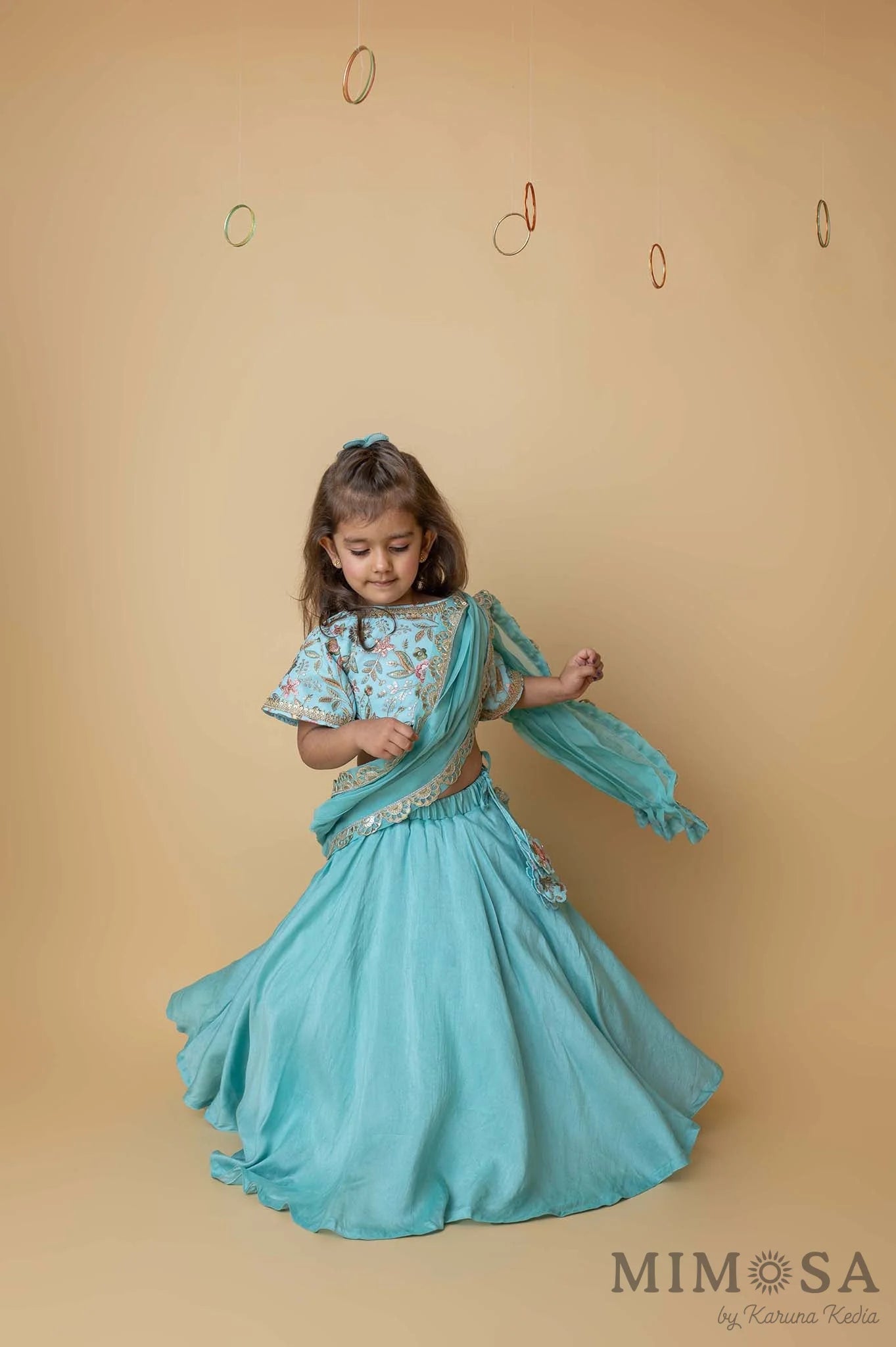 Teal lehenga with embroidered blouse and draped dupatta pallu