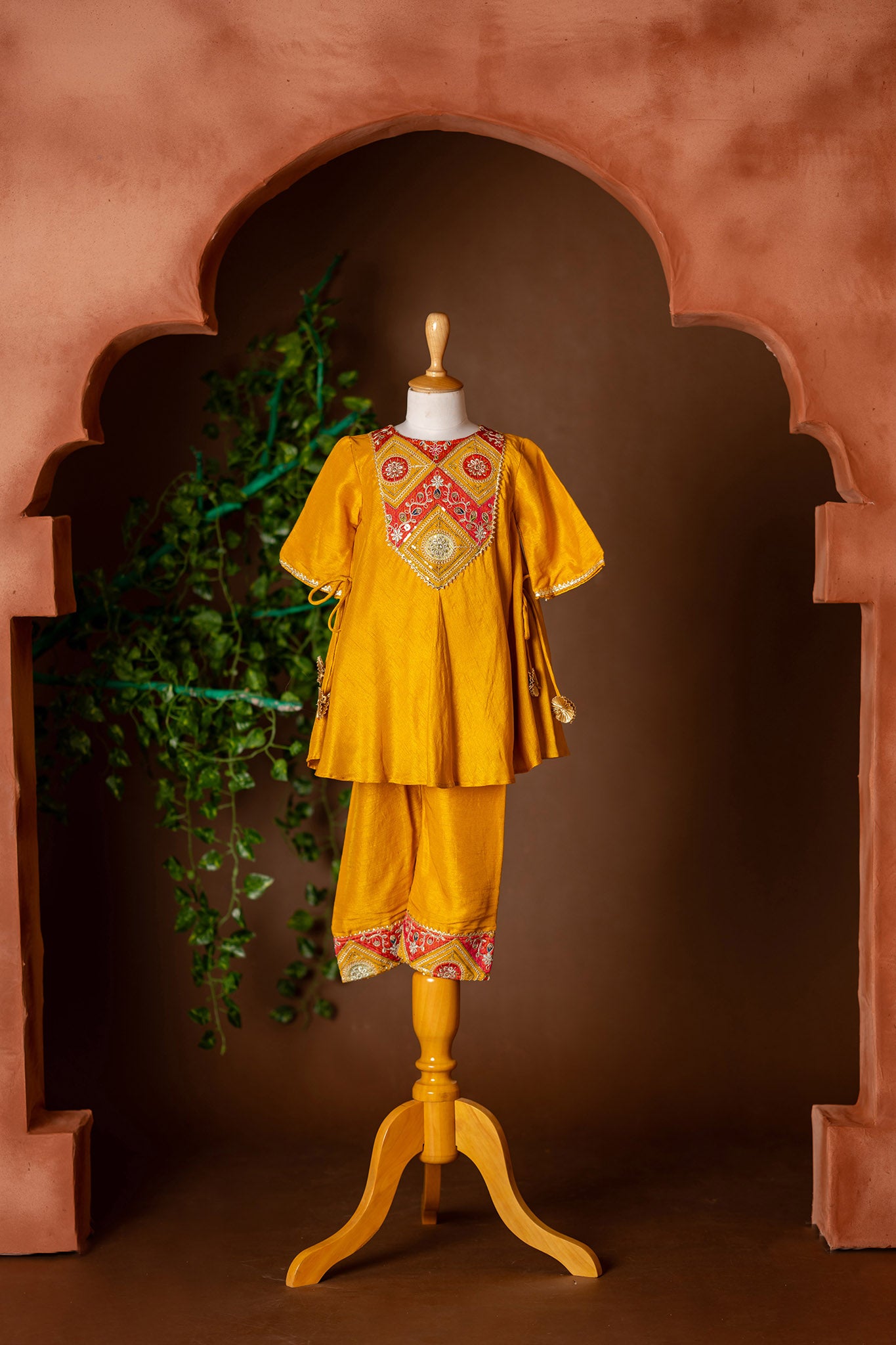 Embroidered yoke, tassel enhanced mustard kurti and pants