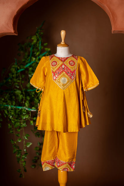 Embroidered yoke, tassel enhanced mustard kurti and pants