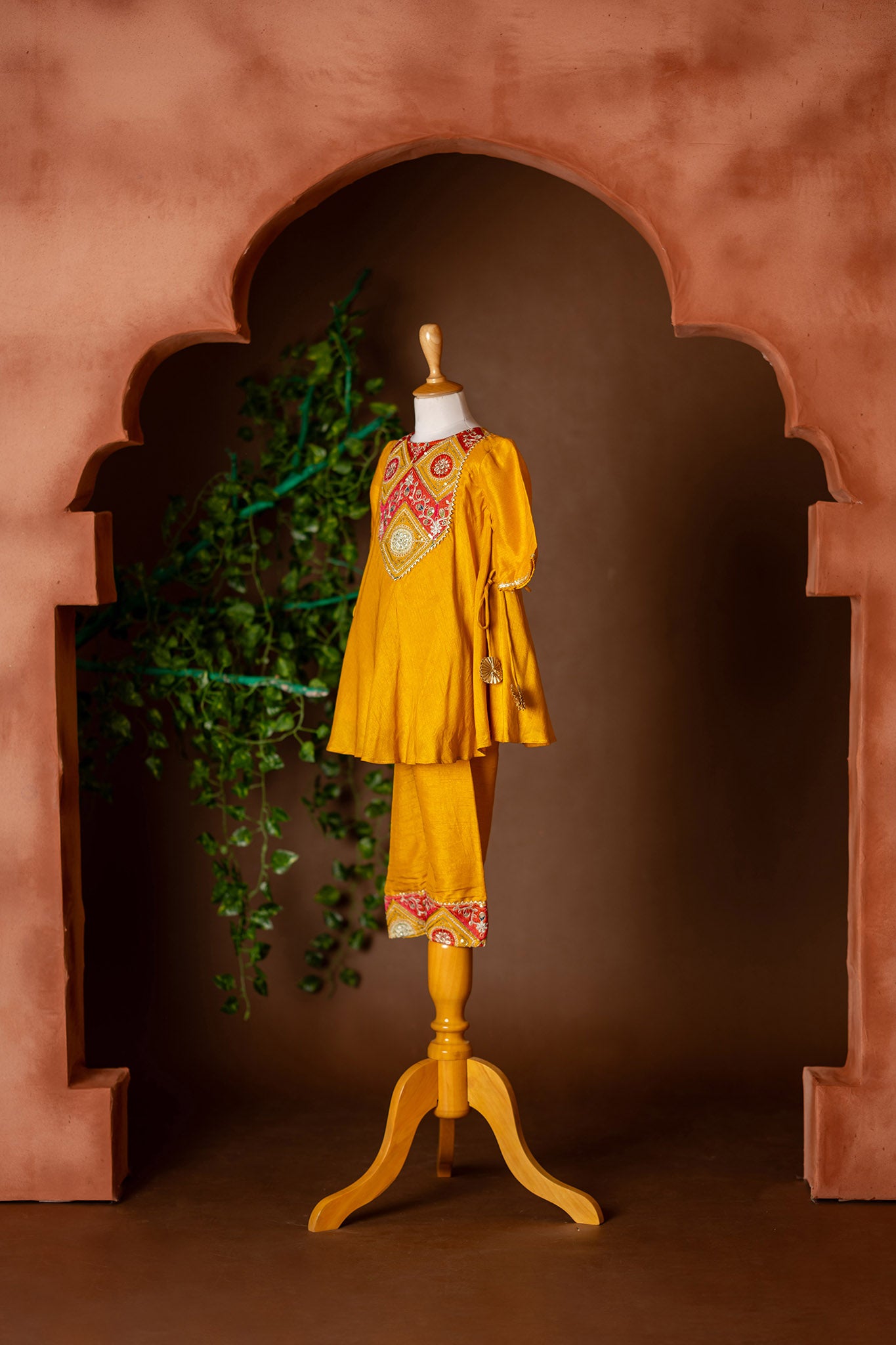 Embroidered yoke, tassel enhanced mustard kurti and pants