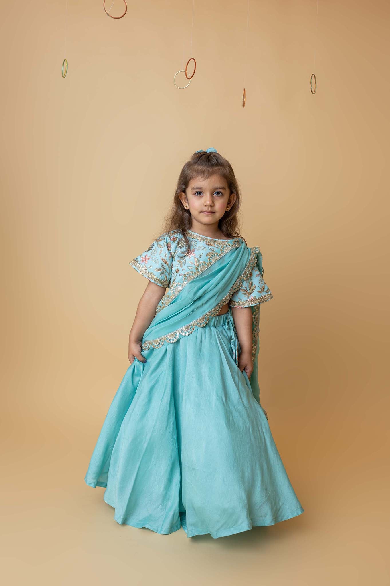 Teal lehenga with embroidered blouse and draped dupatta pallu