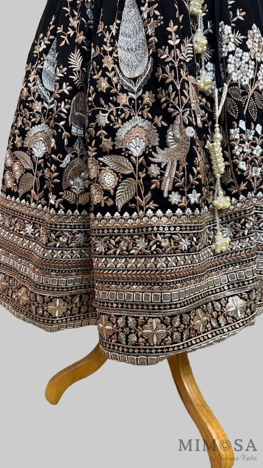 Black embroidered Lehnga paired with a blouse with a yoke and sequince dupatta with fringe border