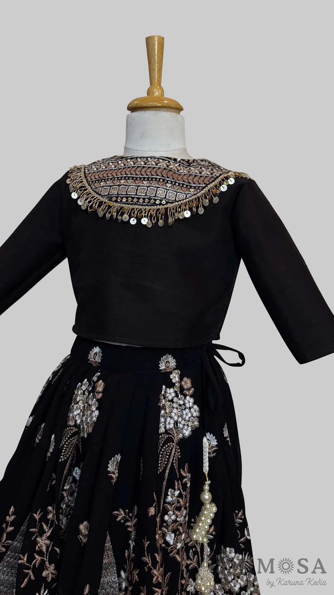 Black embroidered Lehnga paired with a blouse with a yoke and sequince dupatta with fringe border