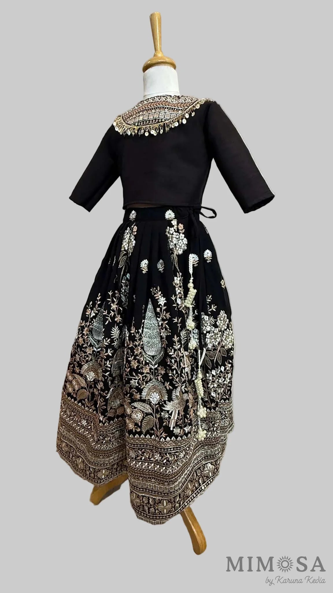 Black embroidered Lehnga paired with a blouse with a yoke and sequince dupatta with fringe border