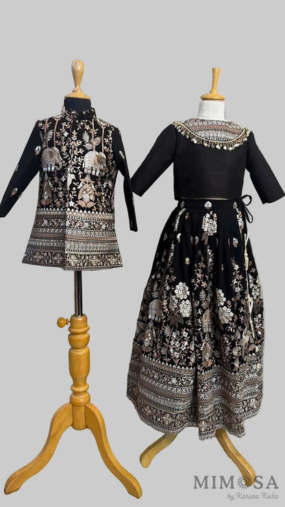 Black embroidered Lehnga paired with a blouse with a yoke and sequince dupatta with fringe border