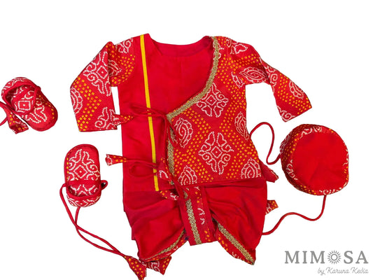Red children's outfit with white patterns on a dark surface