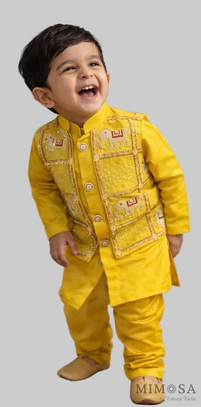 Child wearing a yellow traditional outfit with a smiling expression against a neutral background