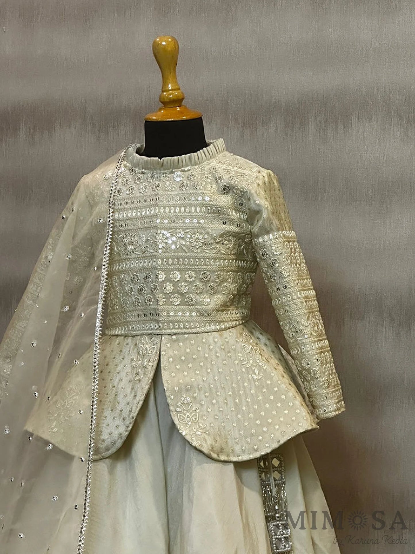 Tissue brocade, peplum blouse with Bamber silk skirt with tassels and organza Dupatta with allover buta